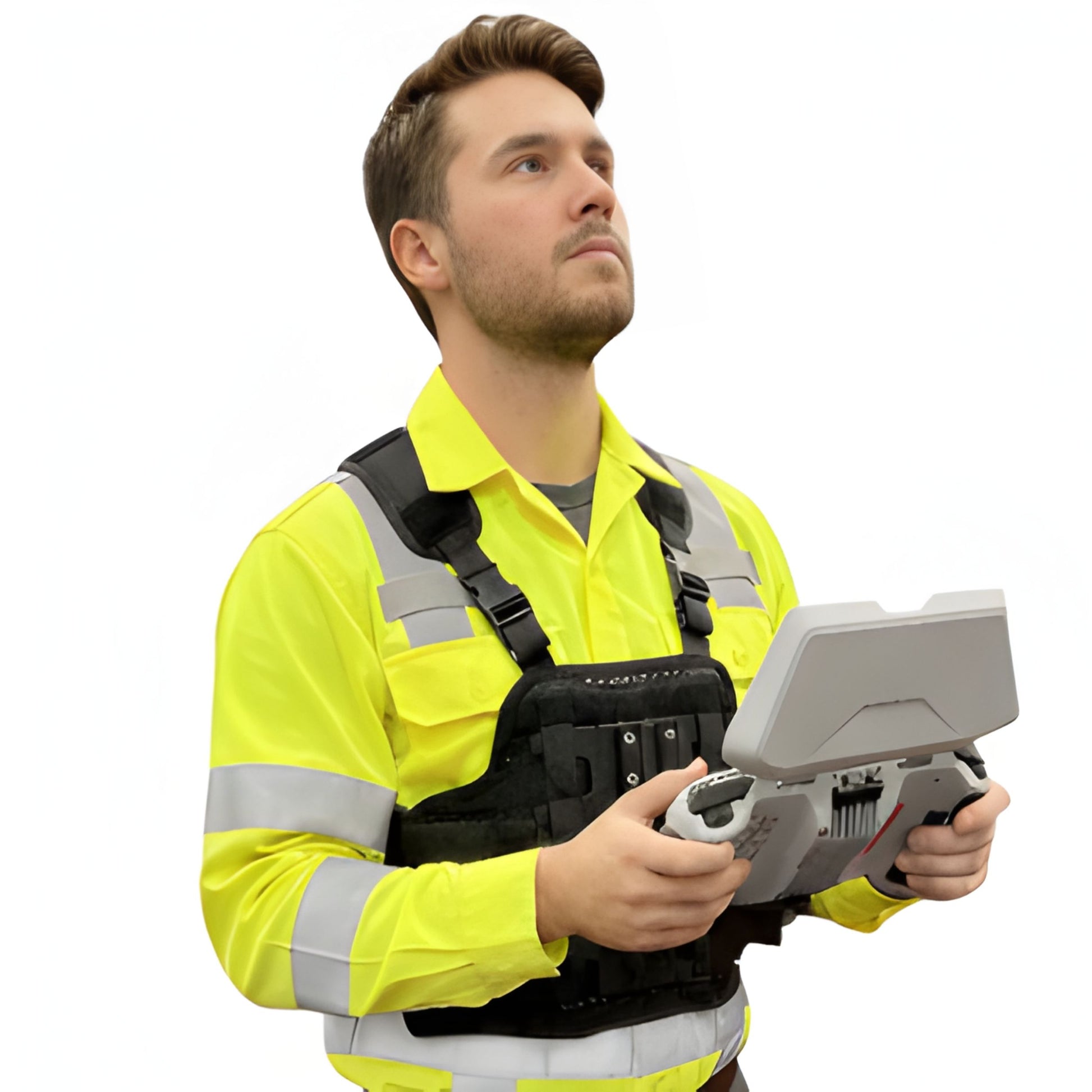 A drone operator looking upward while using a chest-mounted support system for a large drone remote controller with a sun hood for glare protection.
