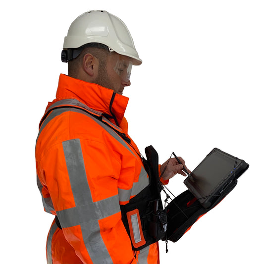 Technician demonstrating the FITEK GEAR High-Viz Ruxton chest pack integrated with a Dell 7230 Latitude rugged tablet.